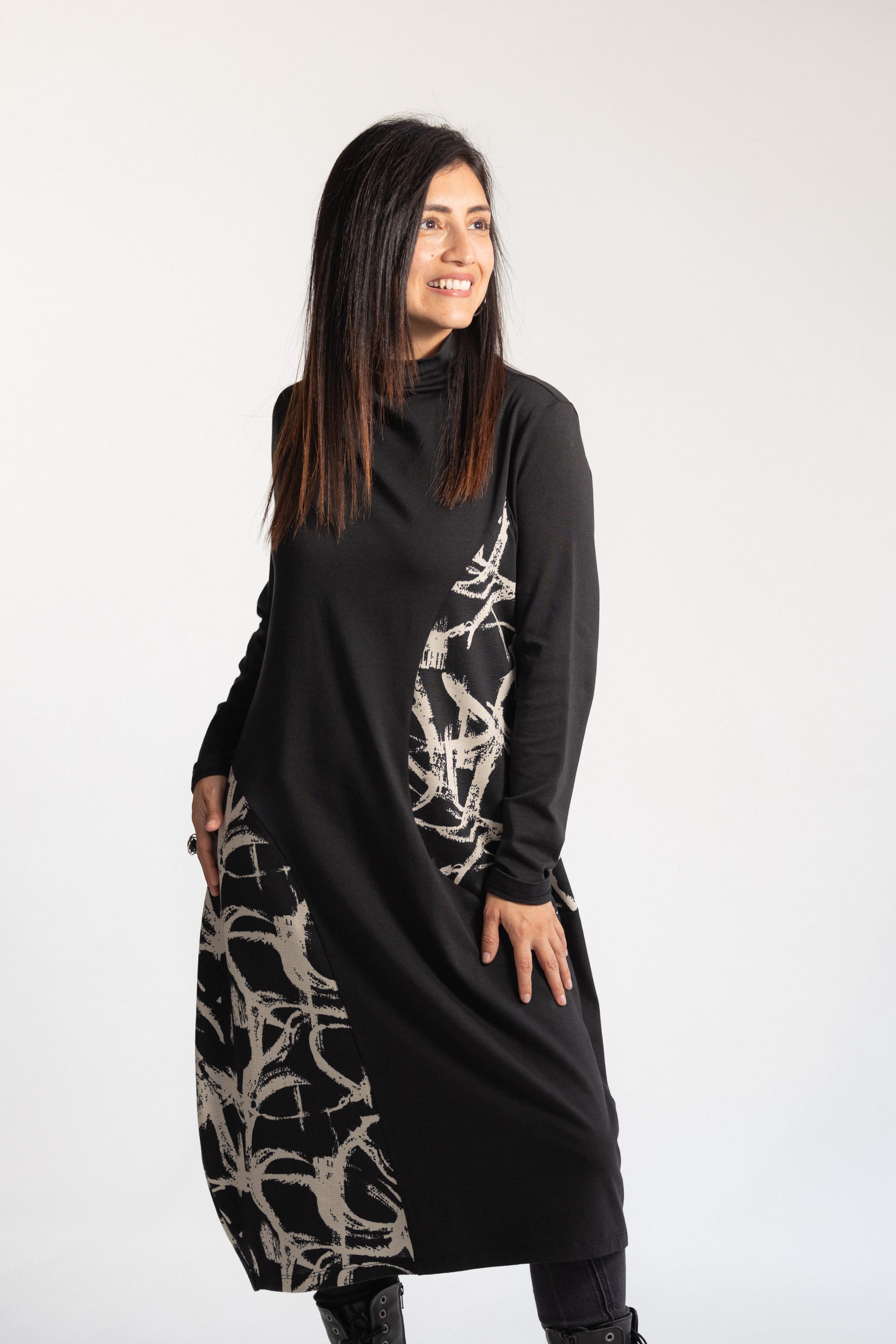 Model wearing black print turtleneck dress