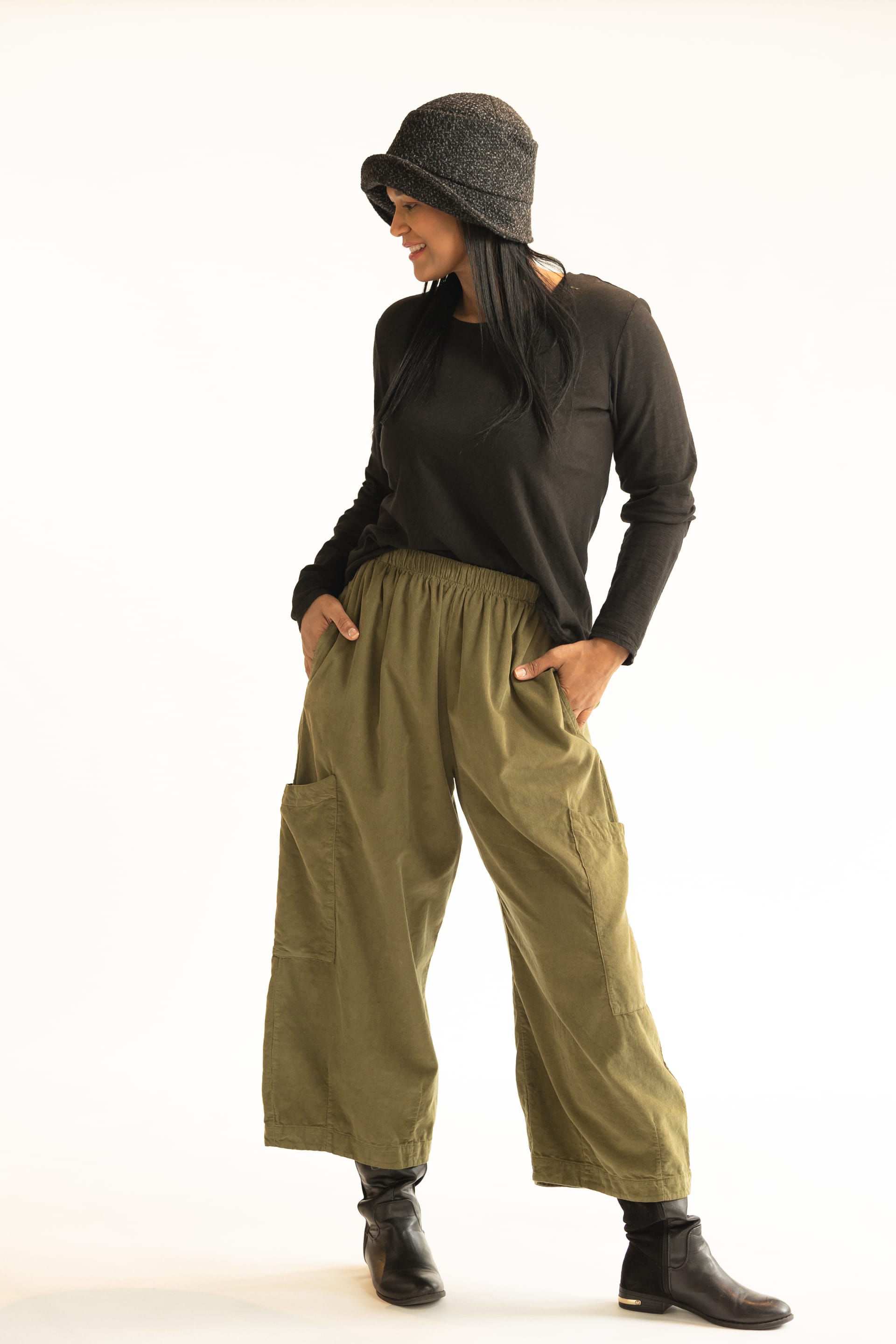Model in black top and olive cargo pants